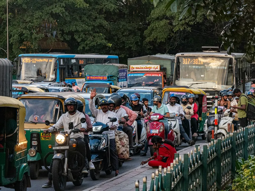 Riders on scooters moving down a street