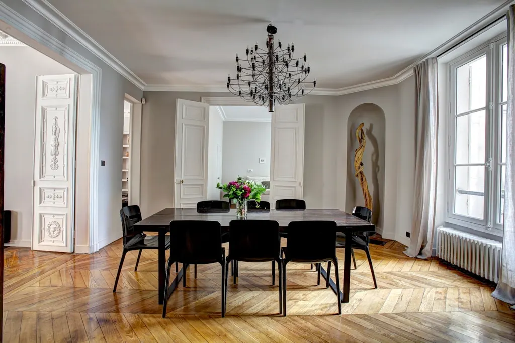 A wooden dining table and chairs in a bare room