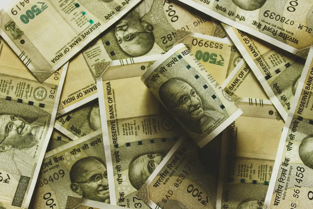 A close photograph of a stack of Indian rupee notes.