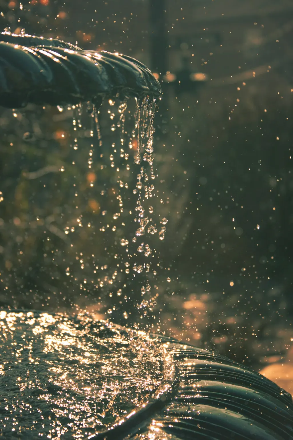 Water overflowing the rim of a stone fountain